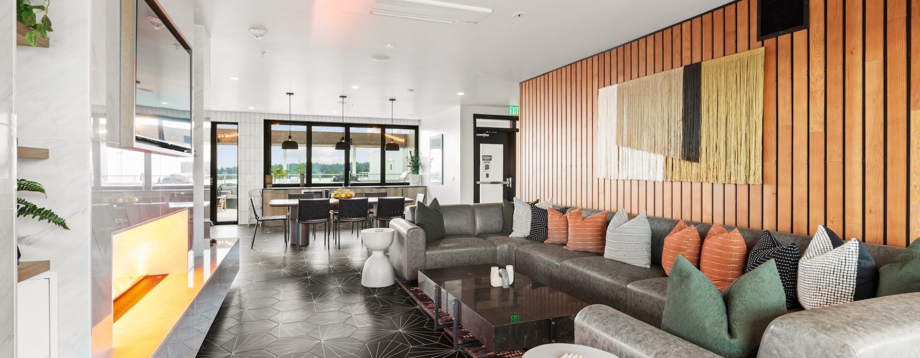 Resident lounge with seating, large screen TV, billiards and access to rooftop terrace.